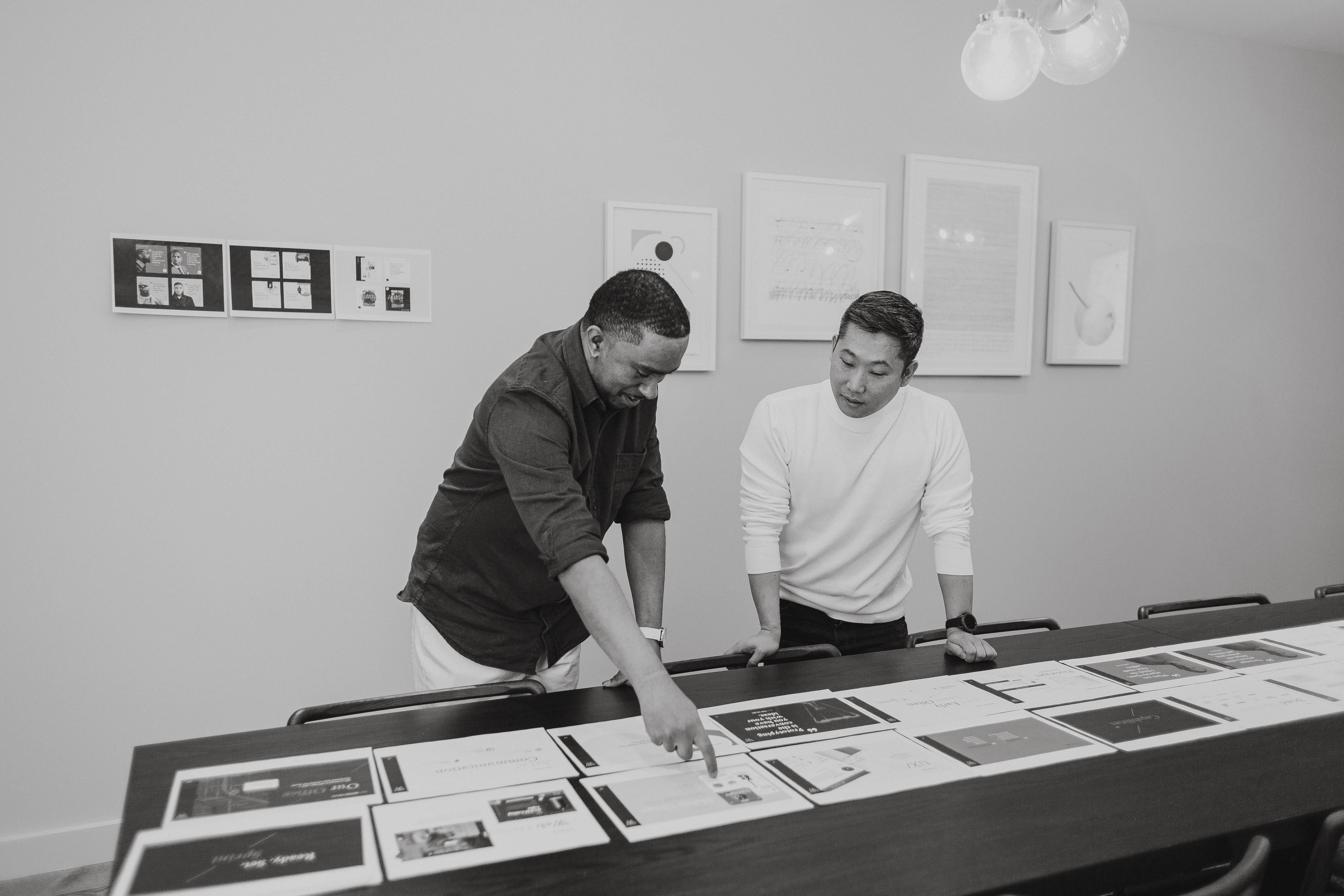 Printed deliverables laid out on a studio table for review